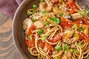 Close up Asian udon noodles with shrimp mushrooms sesame glossy, a Food & Drink Photo by Alexander Prokopenko
