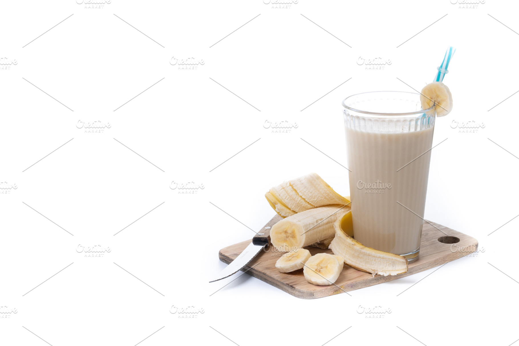 Fresh and healthy banana smoothie in glass isolated on white background, a Food & Drink Photo by etorres69