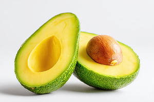 Freshly sliced avocado on white background, a Food & Drink Photo by AlyaAnd
