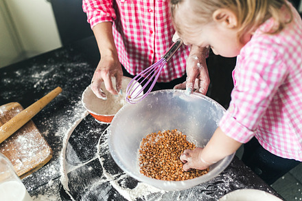 Mom and daughter together in the kitchen containing child, kitchen, and cake, a Person Photo by Tekso