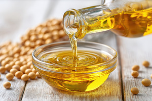 Soy oil pouring into a bowl from a g, a Photo by Pixeness Studio