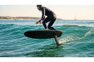 Man in a wetsuit riding an electric, a Sports & Recreation Photo by Igor Tichonow