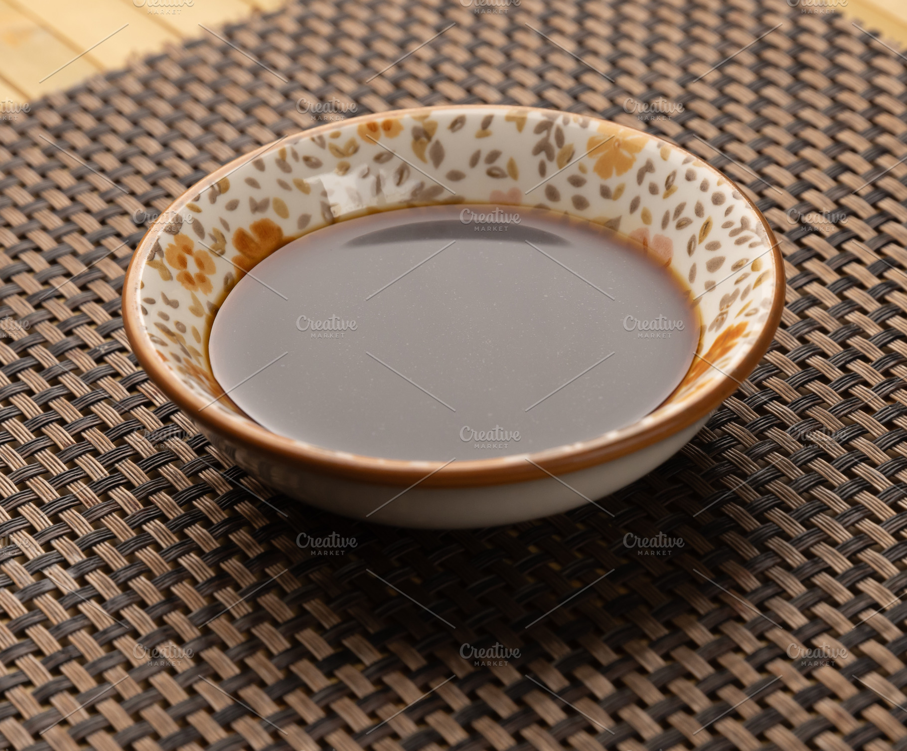 Small bowl containing soy sauce, a Photo by Grafvision photography