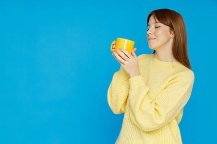 Concept of people, girl with cup on blue background, a Person Photo by AtlasStudio PRO
