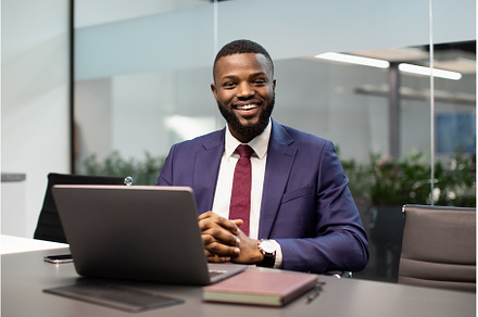 Cheerful black businessman posing at, a Person Photo by Prostock-Studio
