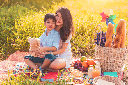 Beautiful Asian mother and son doing picnic and in Easter summer, a Person Photo by Ministocker