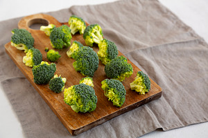 Raw Organic Green Broccoli on a Wooden Board, side view. Copy sp, a Food & Drink Photo by LiudmylaChuhunova