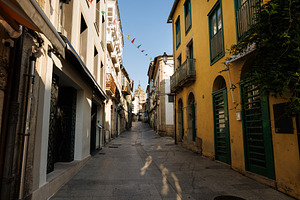Narrow Cobblestone Street with Historic Buildings and Distant Be, an Architecture Photo by Bepslabor