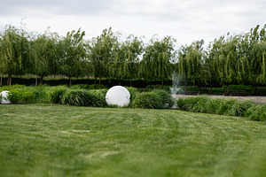 Serene garden setting featuring manicured landscape with decorative foliage and, a Photo by AS photostudio
