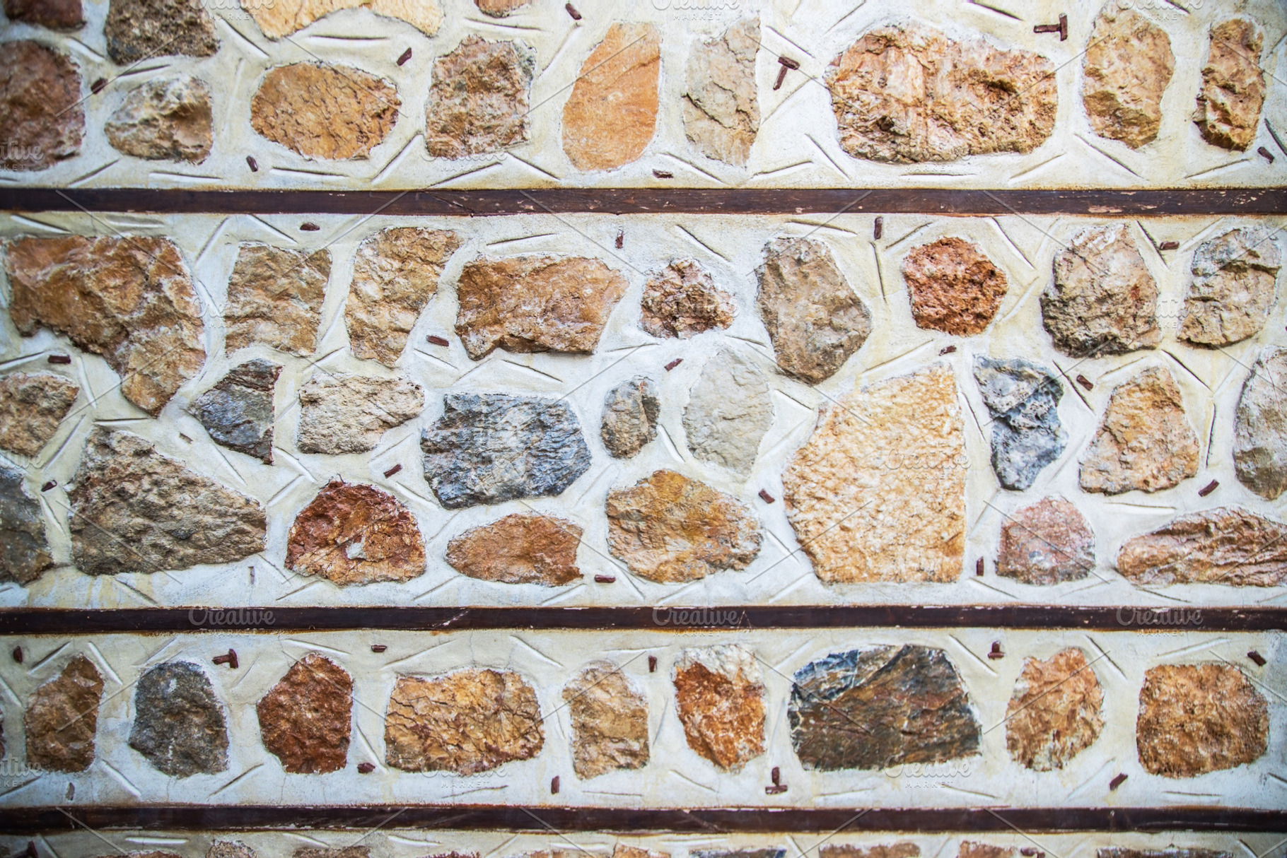 background of concrete gray wall with colored decorative stones, a Holiday Photo by TanaCh