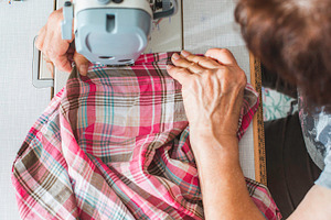 Women sew on sewing machine containing sewing, machine, and woman, an Industrial Photo by Deyan Georgiev