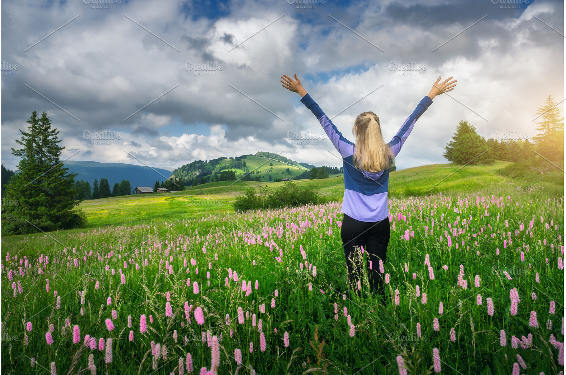 Young woman raising arms standing in, a Person Photo by den-belitsky