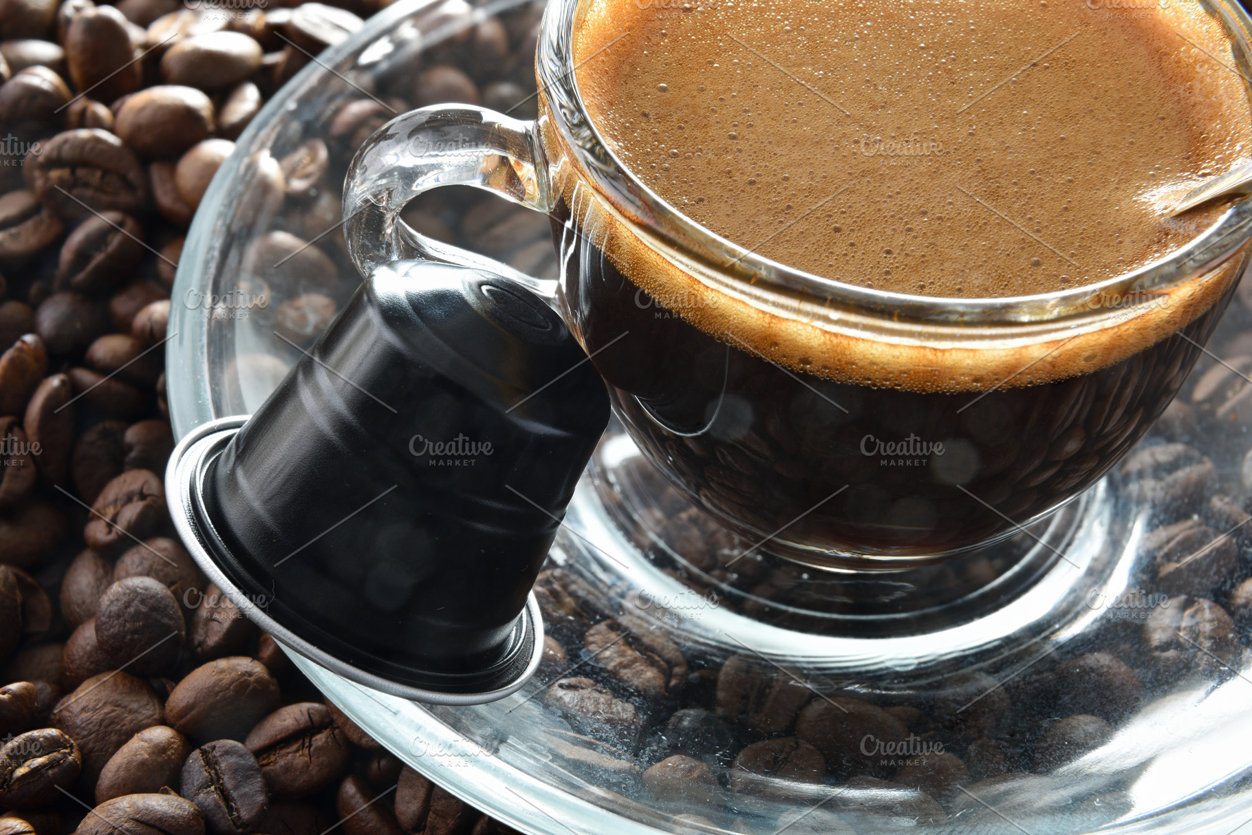 Detail of glass cup of espresso on coffee beans, a Food & Drink Photo by Davizro's Market