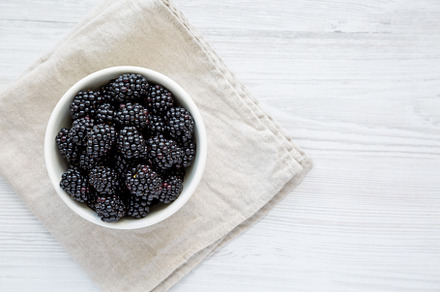 Raw Blackberries in a Bowl, top view. Flat lay, overhead, from a, a Food & Drink Photo by LiudmylaChuhunova