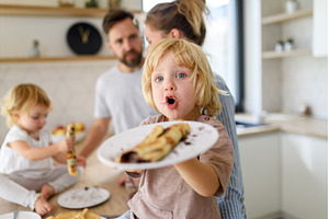 Young nuclear family making pancakes, a Person Photo by HalfPoint