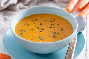 Creamy carrot soup in blue bowl, a Food & Drink Photo by etorres69