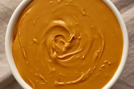Organic Peanut Butter in a Bowl, top view. Flat lay, overhead.