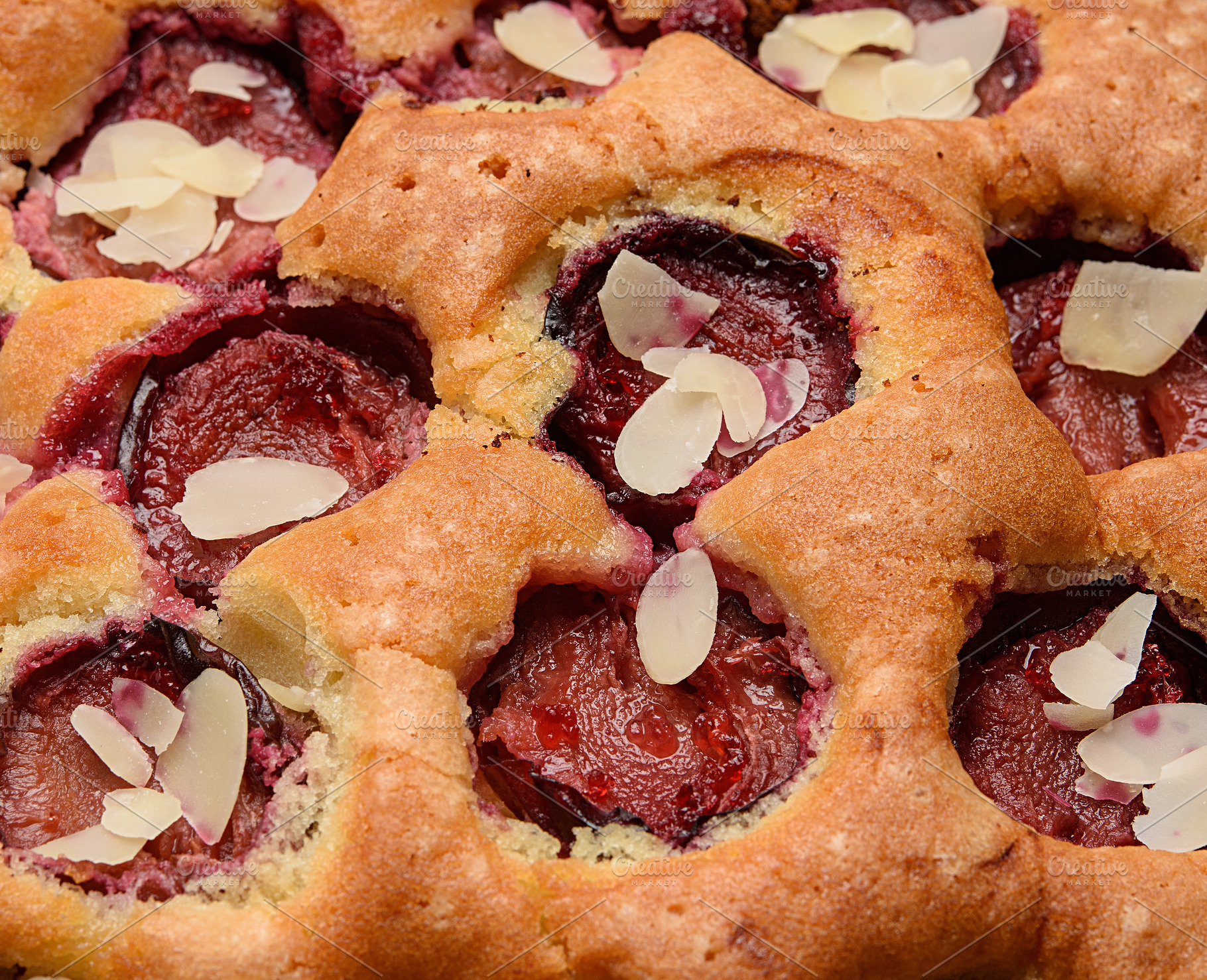 A close-up of a homemade plum pie with plum halves and a sprinkl, a Food & Drink Photo by ndanko