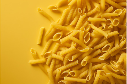 Uncooked penne pasta scattered on, a Food & Drink Photo by Ylivdesign