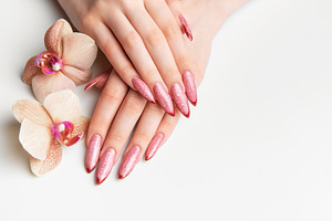 Woman's hands showing manicure with pink glitter nails and orchi, a Beauty & Fashion Photo by Olena Rudo