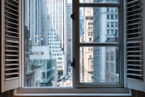 City window view with buildings, a Photo by Beautiful things