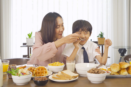 Portrait of happy smiling Asian Family eating breakfast food tog, a Photo by Tampatra