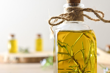 Rosemary essence in glass jars with fresh twigs on table, a Health & Medical Photo by Davizro's Market