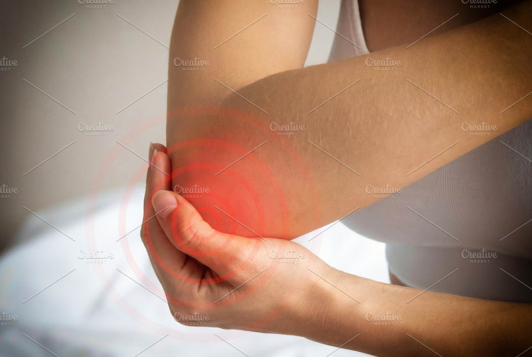 Woman Holding Painful Elbow With Red Highlight, a Health & Medical Photo by Davizro's Market