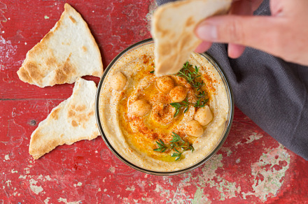 Chickpea hummus with paprika, olive oil and pita bread, a Food & Drink Photo by Antonina Vlasova