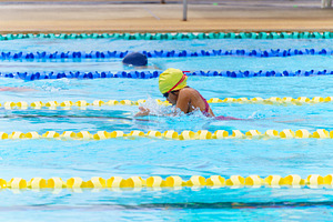 Swimmer child swims breaststroke swimming style in a race swimmi, a Sports & Recreation Photo by Casanowe-studio