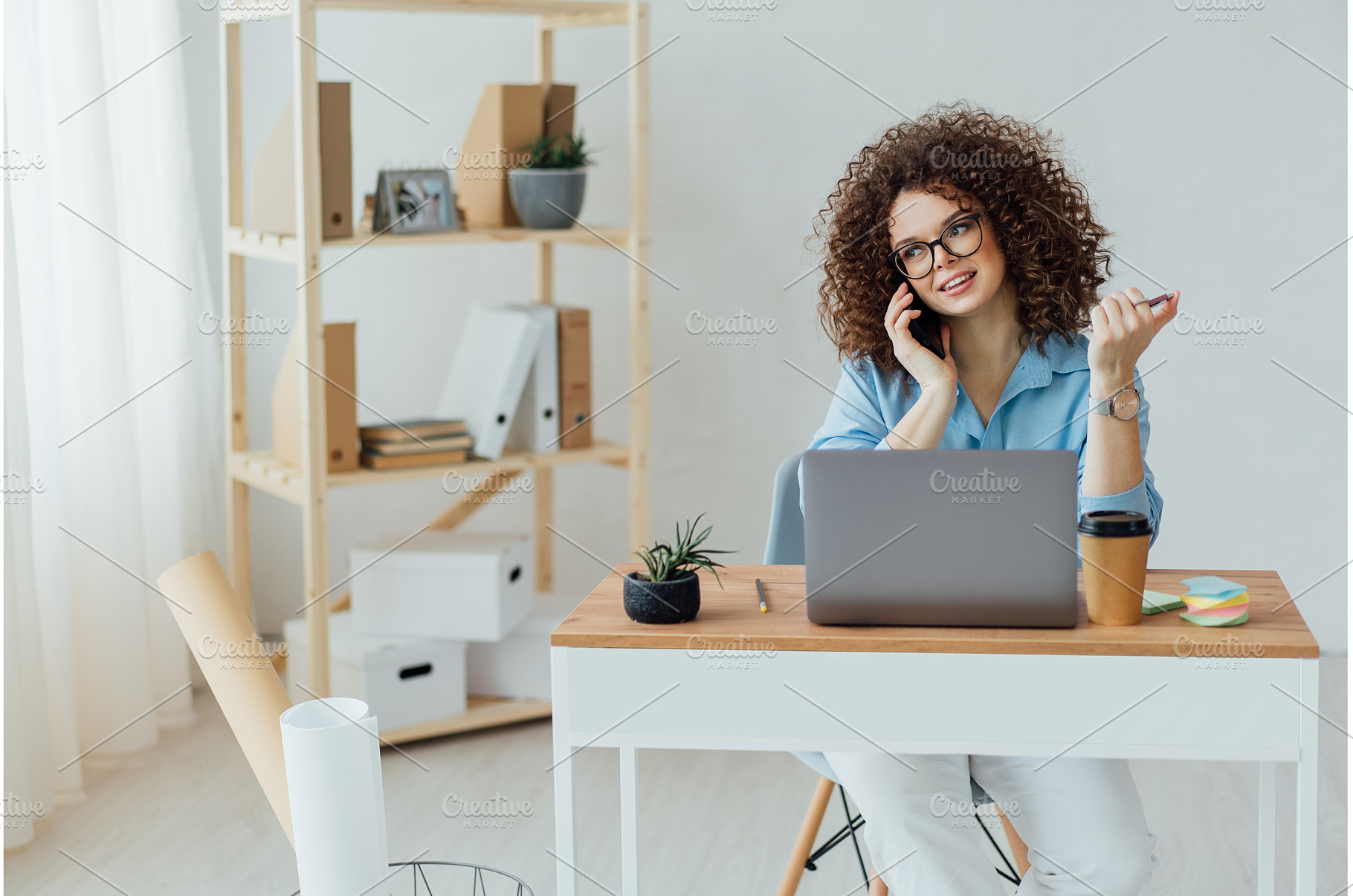 Young curly woman work on the, a Business Photo by Ksenia Neyman