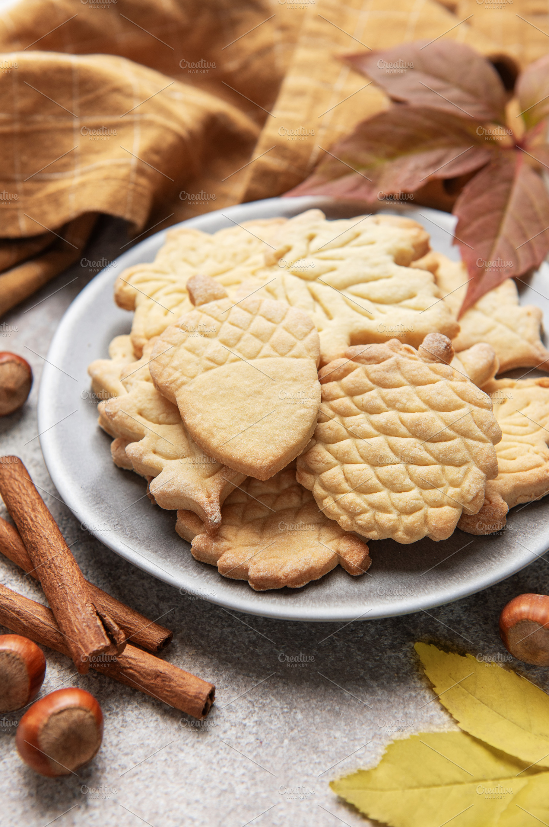 Autumn cookies on plate with cinnamon and hazelnuts, a Food & Drink Photo by Olena Rudo