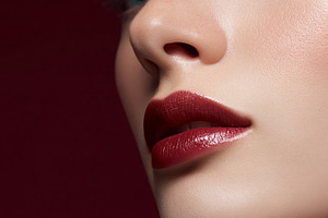 Woman's profile showcasing perfectly applied deep red lipstick,, a Beauty & Fashion Photo by Studio ANNA