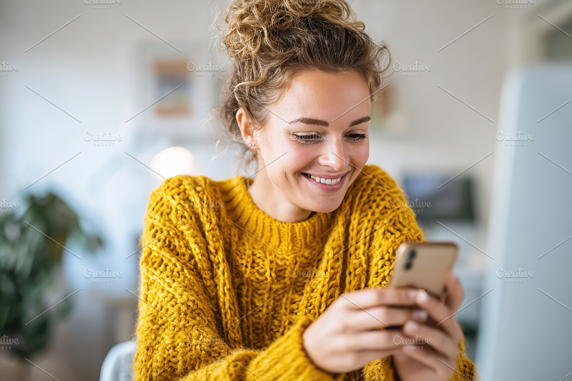 Smiling woman enjoys moment while turning off her smartphone in cozy indoor spa, a Person Photo by AlyaAnd