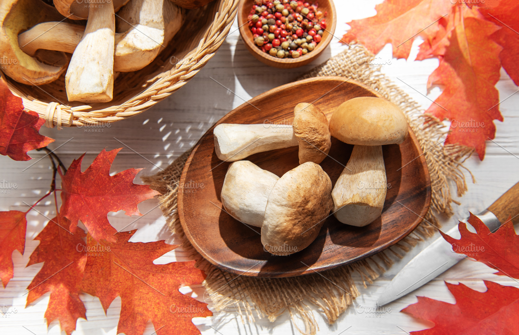 Porcini mushrooms harvest with red autumn leaves, a Food & Drink Photo by Olena Rudo