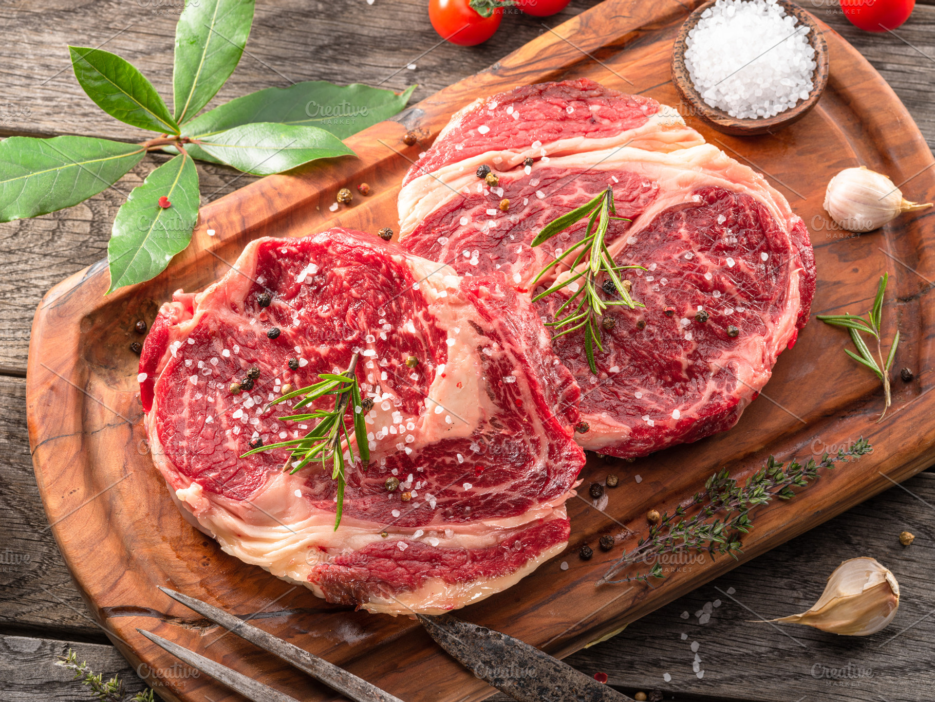 Raw beef steaks with herbs, a Food & Drink Photo by Volff