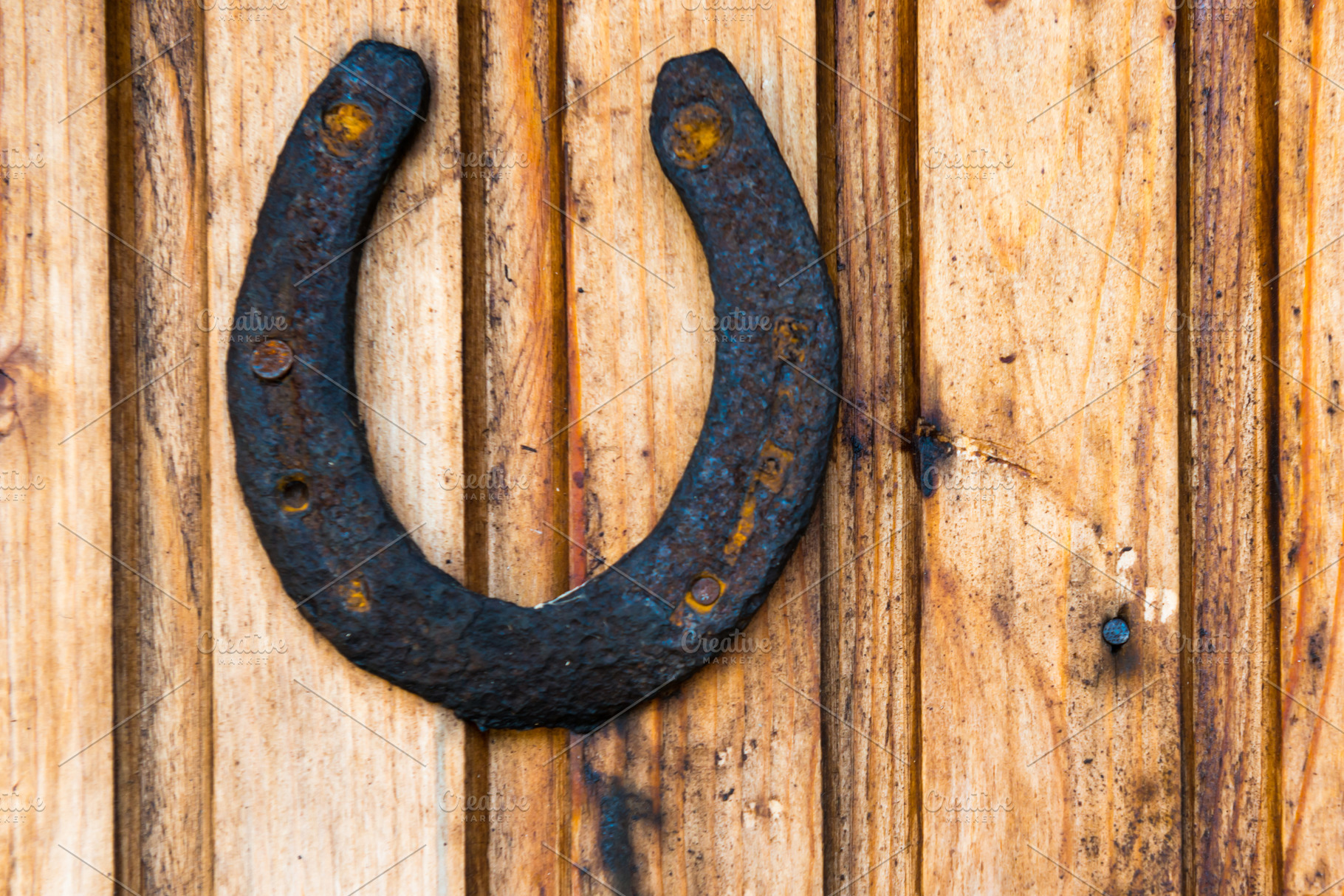 Old rustic horseshoe on wooden wall, a Nature Photo by Vapi