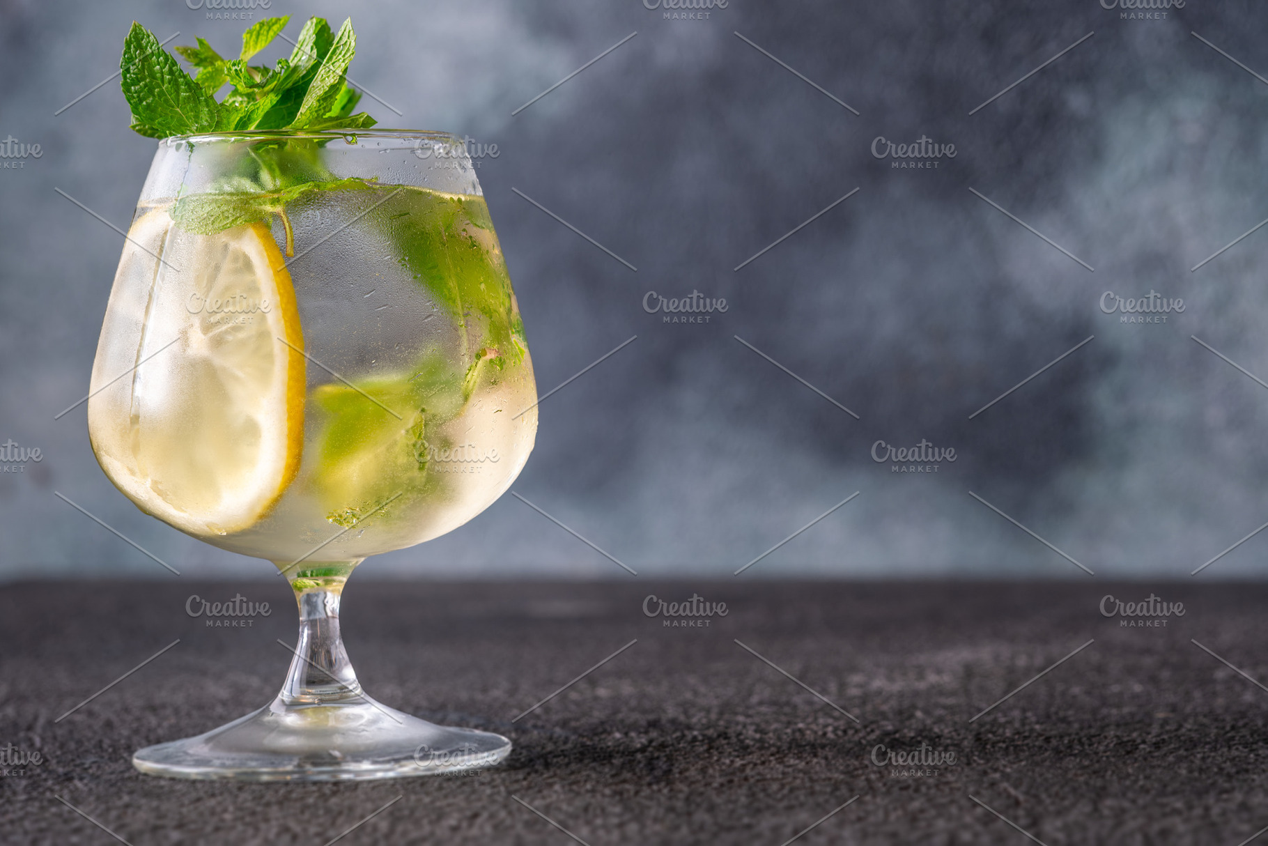 Refreshing Hugo Spritz cocktail with lemon mint ice bubbles and, a Food & Drink Photo by Alexander Prokopenko
