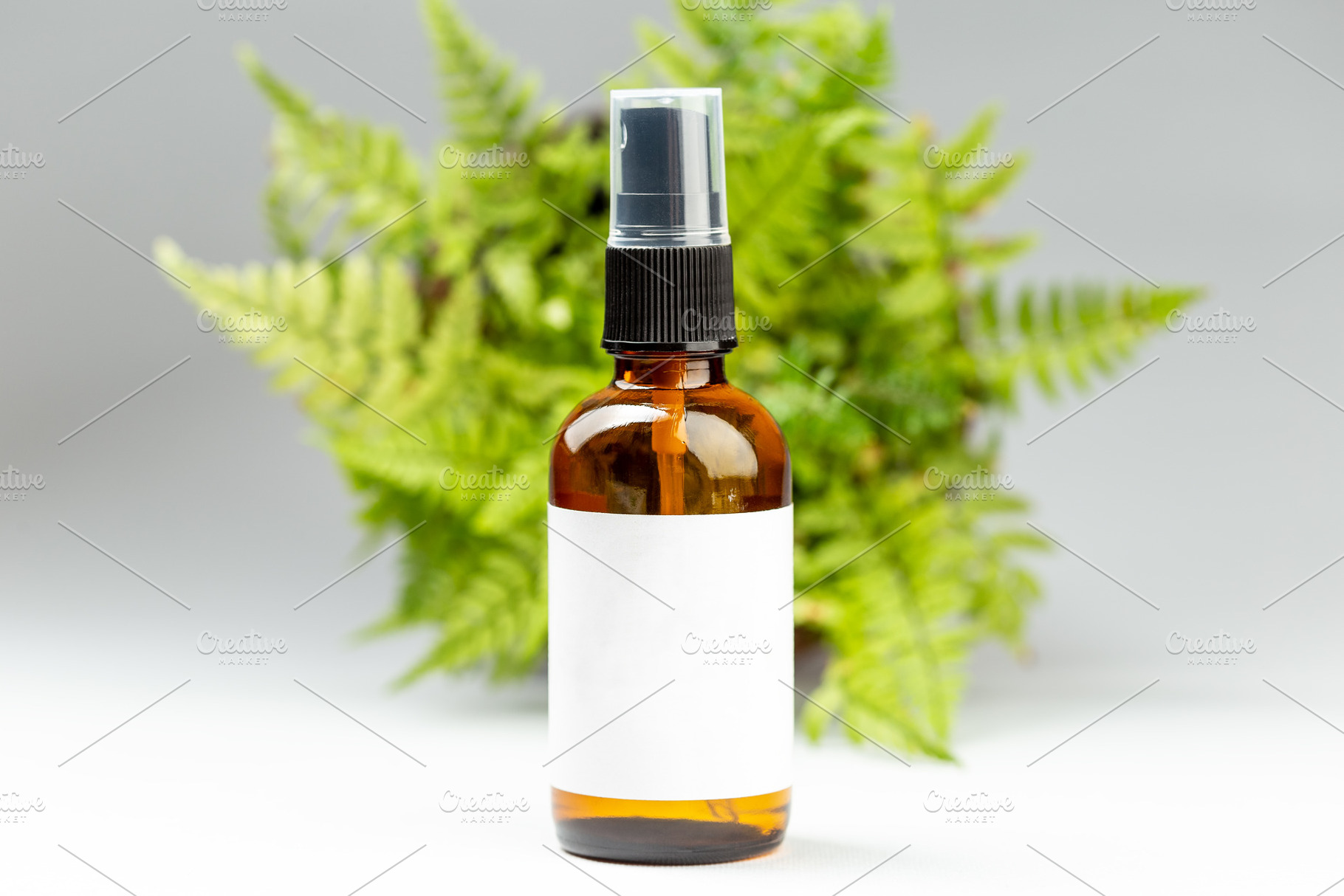Glass spray bottle with white label, a Beauty & Fashion Photo by Andriana Syvanych