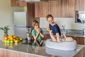 Mother and son preparing smoothie in, a Person Photo by Elizaveta Galitskaya