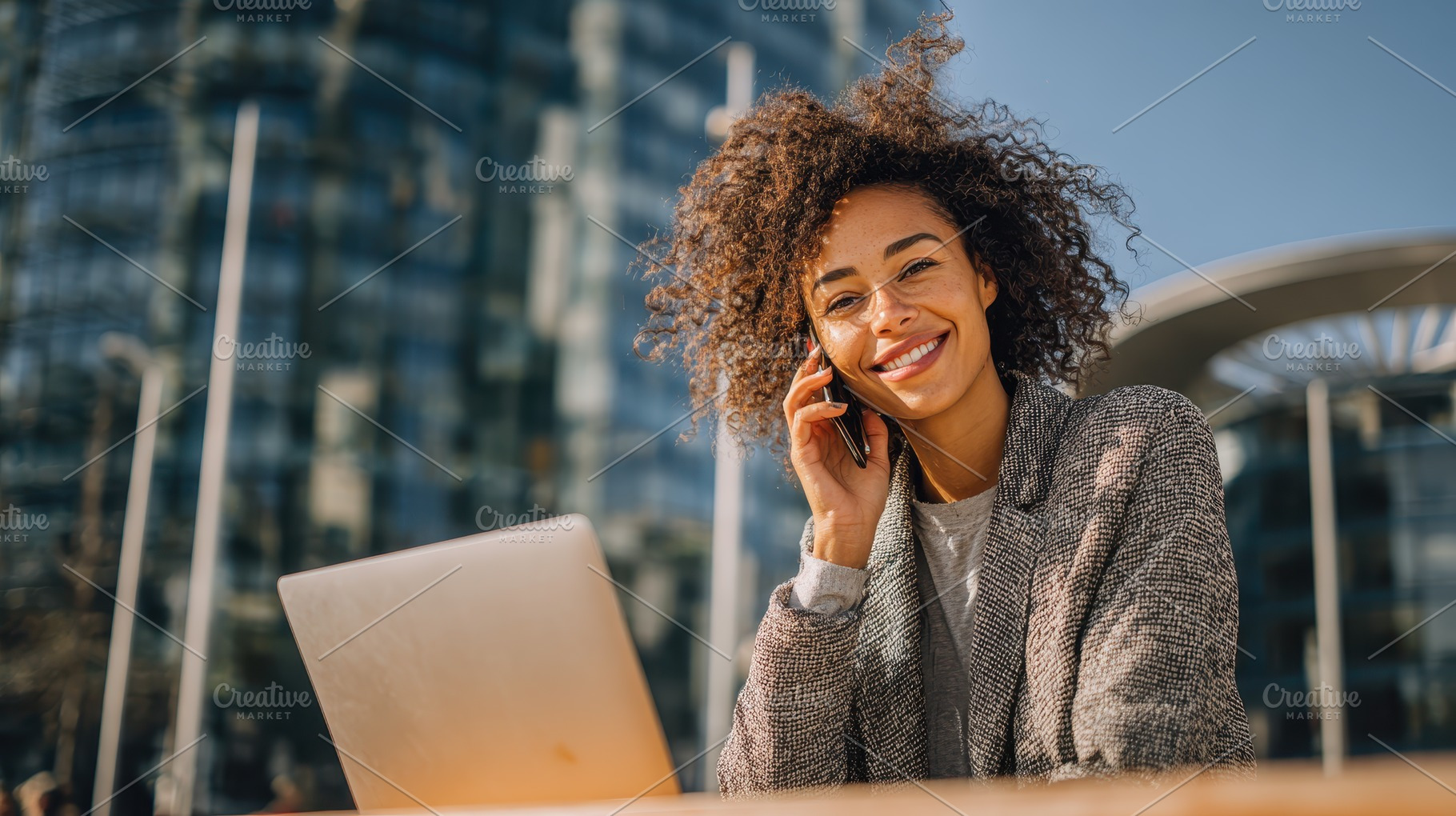 Happy businesswoman working outdoors, a Photo by Pixeness Studio