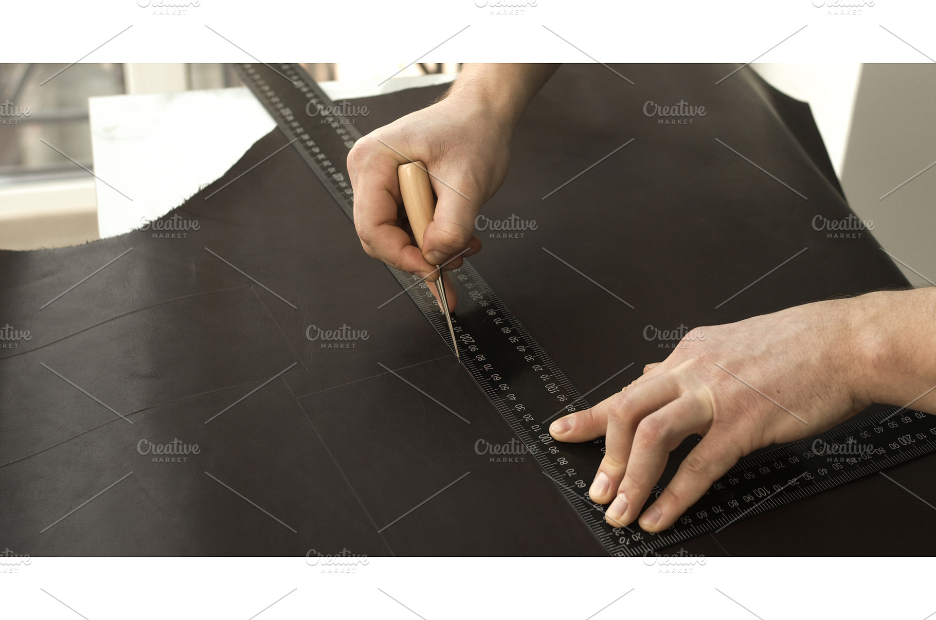 Measuring and marking leather with, a Person Photo by volodymyrshtun13795