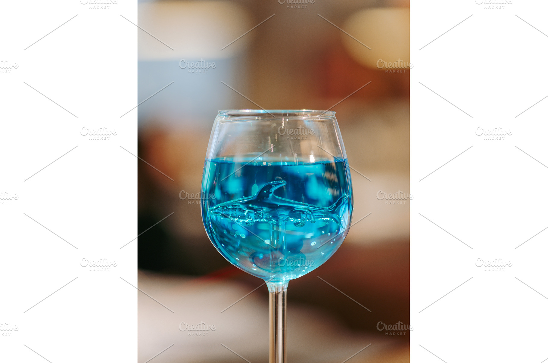 Glass of blue lagoon cocktail on bar, a Food & Drink Photo by Fascinadora