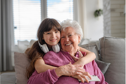 Cute girl hugging gradmother from, a Technology Photo by HalfPoint