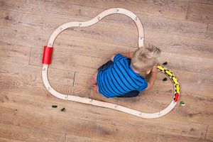 Boy playing with his train set