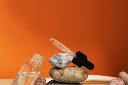 Bottle white glass with dropper on orange background. Natural co, a Beauty & Fashion Photo by matucha
