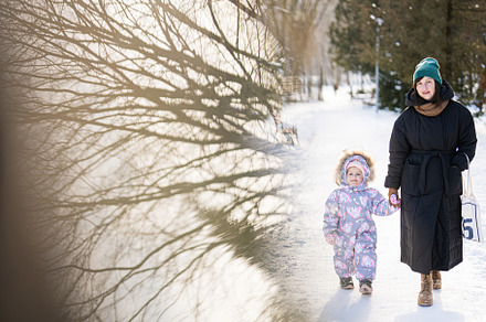Mother and child walking on a sunny frosty winter day in the par, a Person Photo by AS photostudio