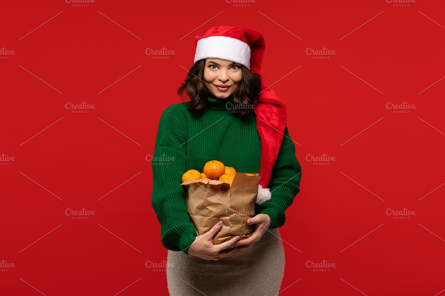 Woman in Santa hat holding bag, a Holiday Photo by Elena Vagengeim