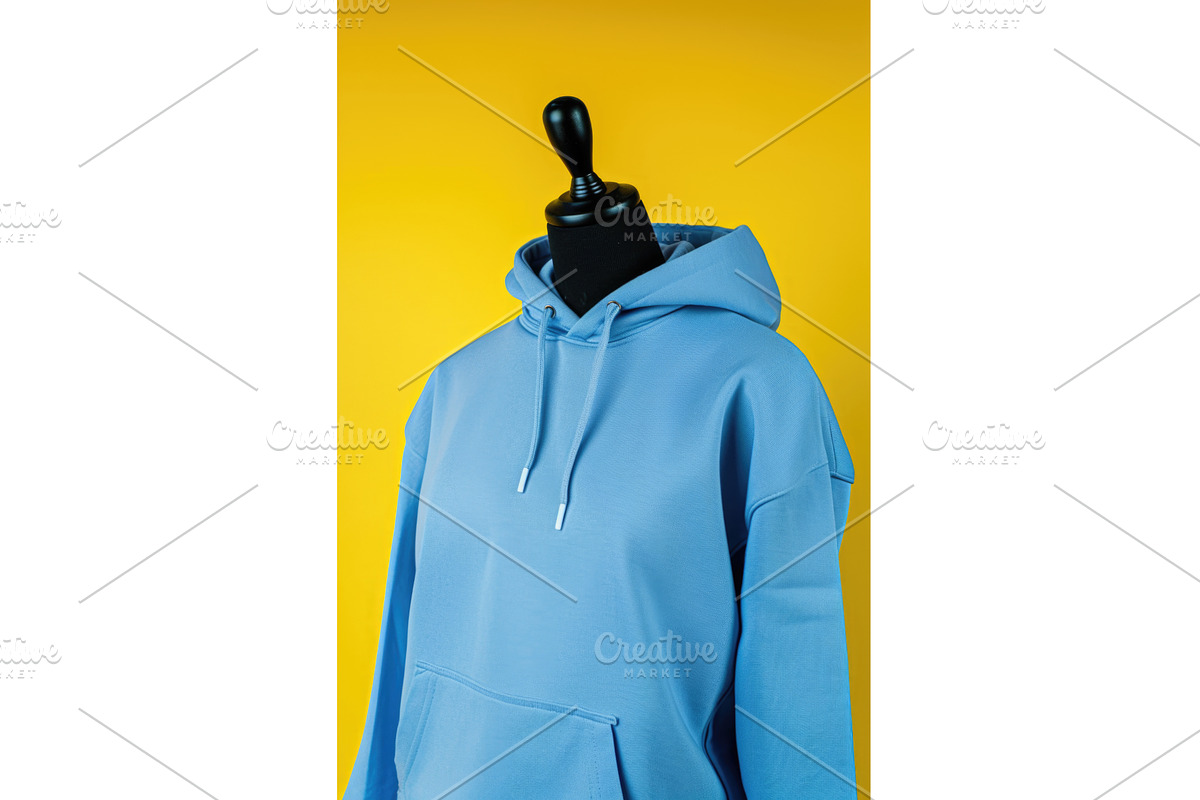A blue hoodie on a mannequin on a, an Illustration by tilialucida