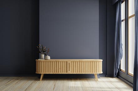 Modern living room decor with a tv cabinet and dark blue wall background.